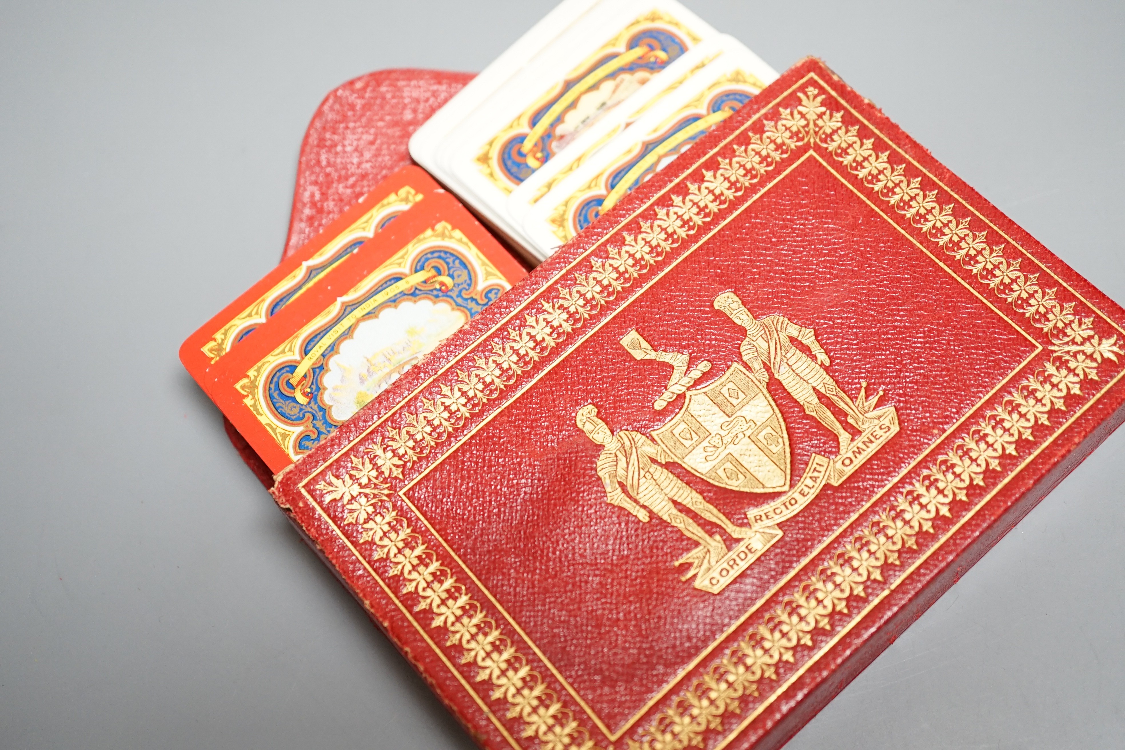 Two packs of Edwardian Royal commemorative playing cards with red morocco leather case, gilt decorated with an armorial